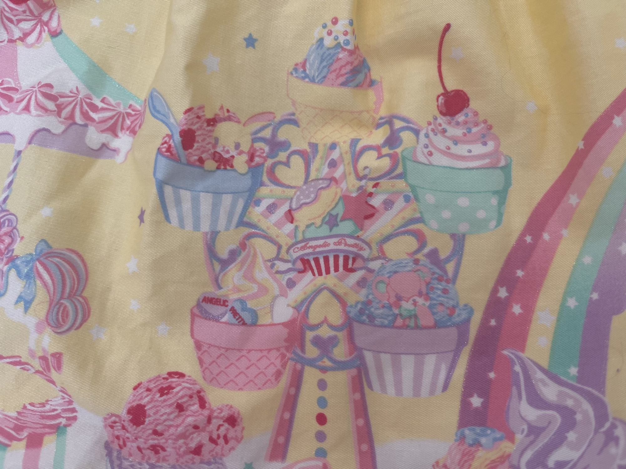An up-close photo of Lyrical Bunny and Shyness Bear on the ferris wheel of Milky Planet's border print.