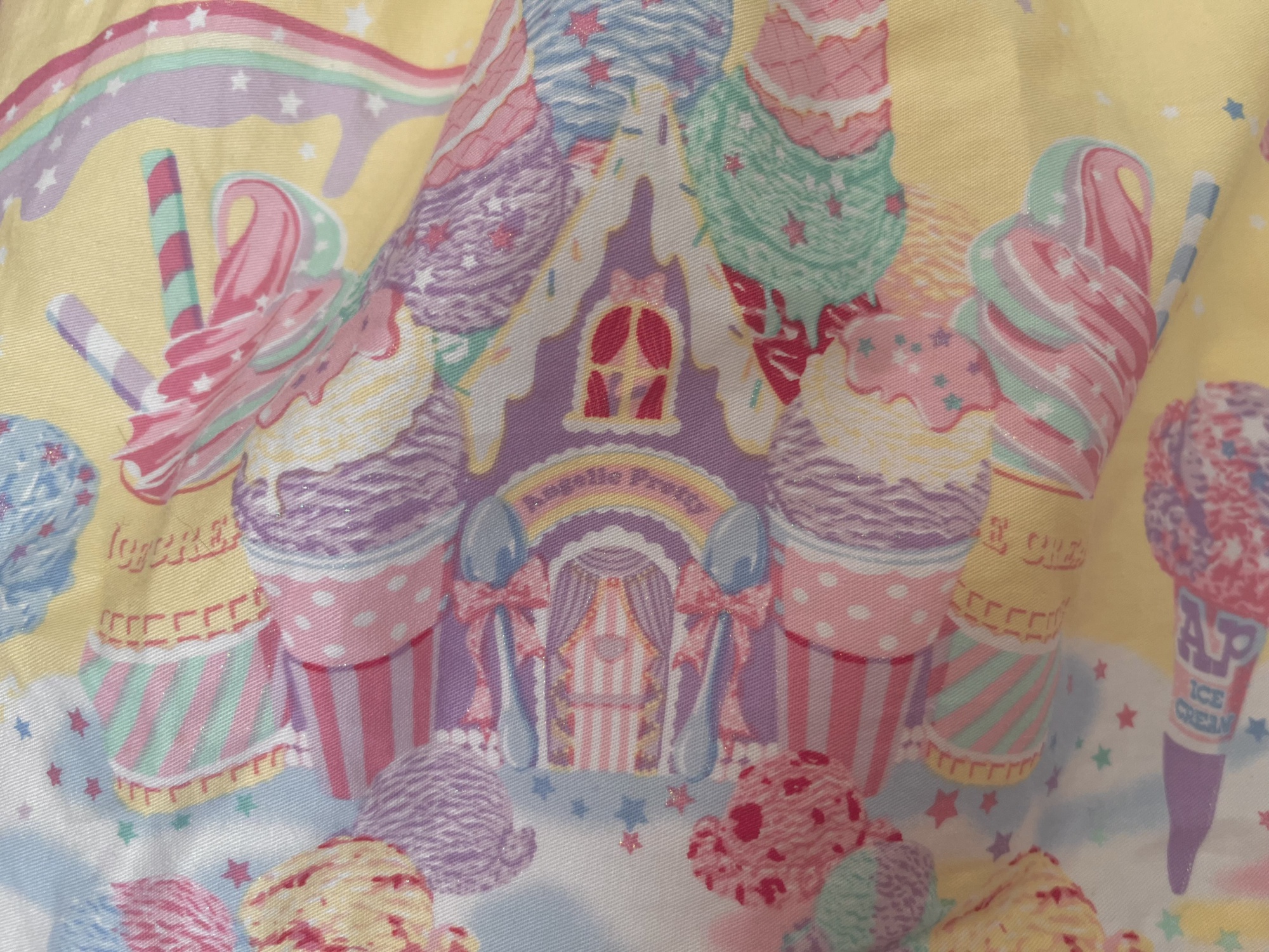 An up-close photo of the ice cream-covered house on Milky Planet, which has a bunny in the upper window.