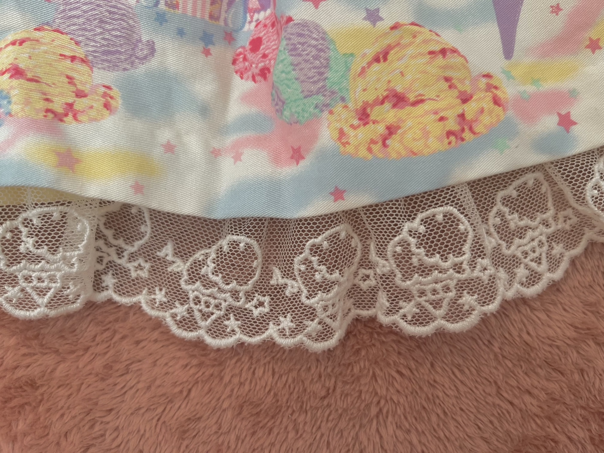 An up-close photo of the lace on Milky Planet, which is white with an ice cream design.
